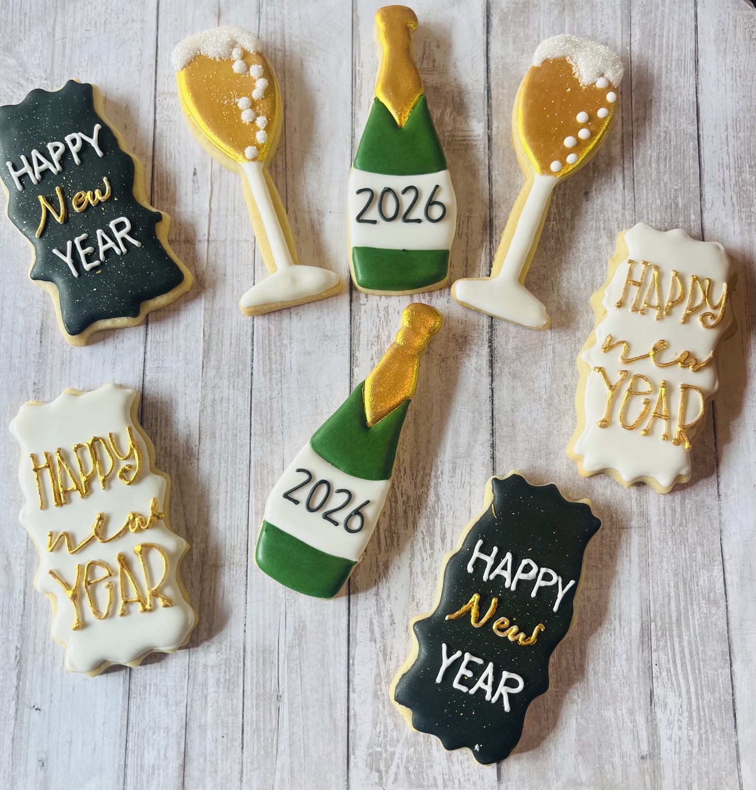 Black, white, green, and gold New Year 2026 cookies